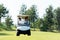 Golfer sport course golf ball on green grassÂ  People lifestyle man and friend siting on car golf in fairway.Â 